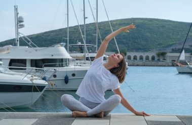 Young,Slim,Beautiful,Woman,Practicing,Yoga,In,The,Marina,,Against