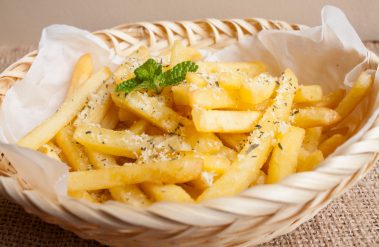 French,Fries,With,Parmesan,Cheese,On,A,Rattan,Plate